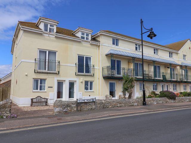 A house with balconies and a street sign at 2 Lyme Mews in Seaton