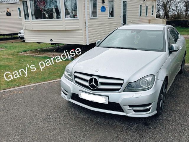 A car parked in front of a holiday home at Gary's Paradise in Driffield