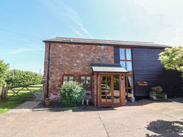 A stone and wooden exterior view of Little Owl Barn in Wellington