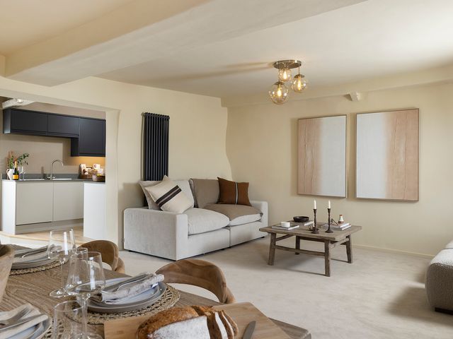 A living room with a sofa and coffee table at Church Alley House in Stow-On-The-Wold