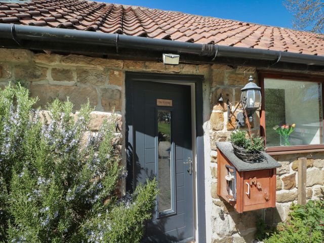 An entrance door and mailbox with plants at The Cottage in Stokesley