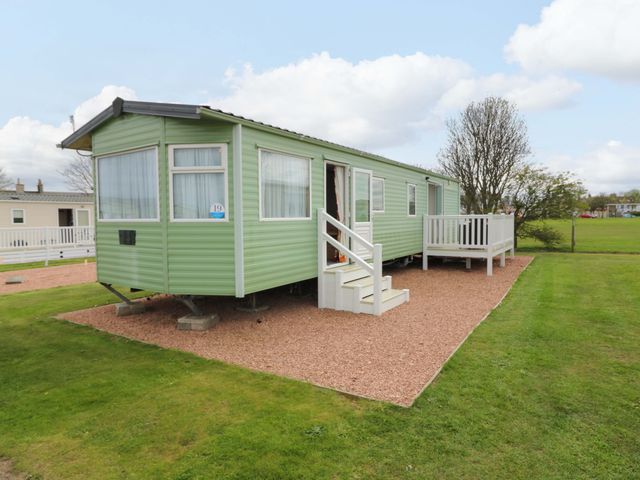 A mobile home with steps and decking at St Monans Holiday Park - Holiday Accommodation 19927 St Monans