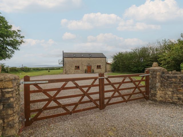 A house with a gravel driveway and gate at The Gallops in Barry