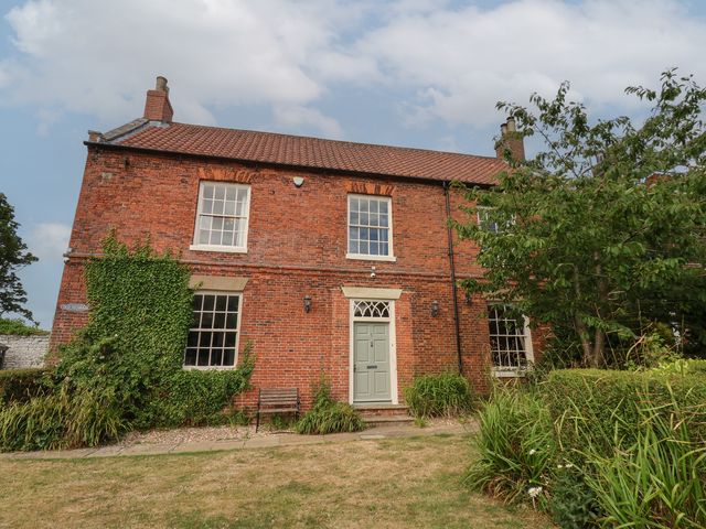 A brick house with a garden at Reighton House Reighton near Filey