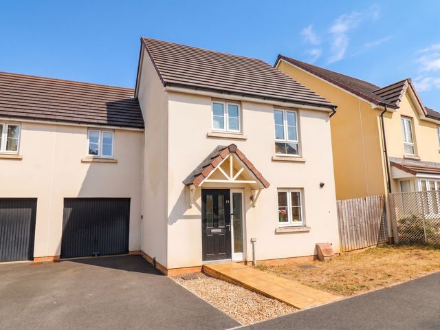 A house with a driveway and garden at 24 Higher Gorse Road in Roughton