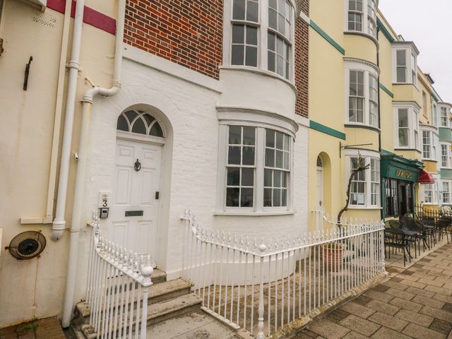 An outdoor area with a door and windows at No 3 By The Sea in Weymouth