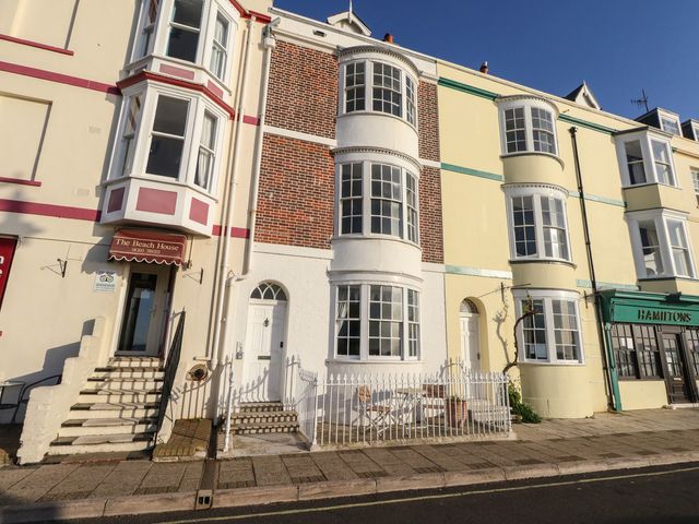 A building facade with windows and entrance at Number 3 by the Sea in Weymouth