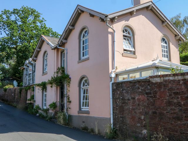 A house with windows and brick wall at Gorway Cottage in Teignmouth