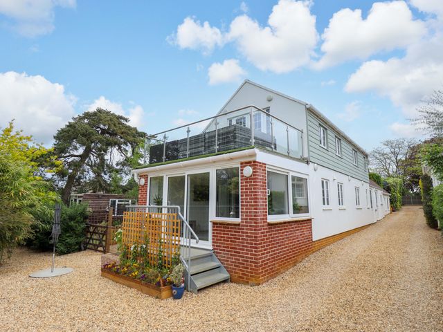 A house with a balcony and garden at The Hen House