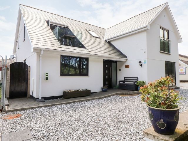 A house exterior with a front door and garden at Seagull Shack Morfa Bychan