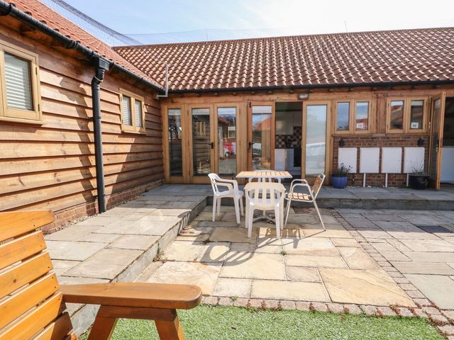 An outdoor area with a table and chairs at 5b Hideaways in Hunstanton