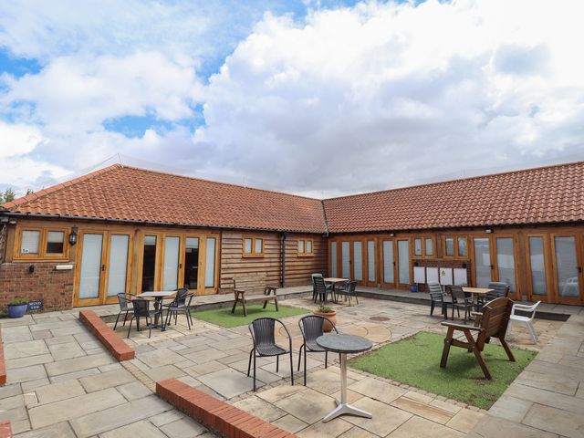 An outdoor area with tables and chairs at 3b Hideaways in Hunstanton