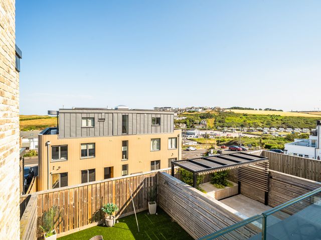 A balcony view of buildings and greenery at Seascape in Newquay