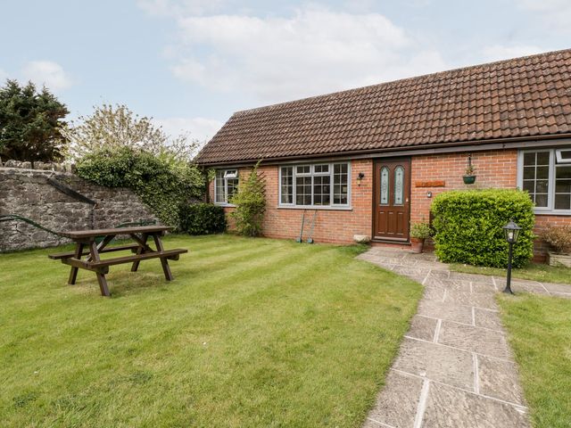 A house with a picnic table and garden at Oak Tree in Weston-super-Mare
