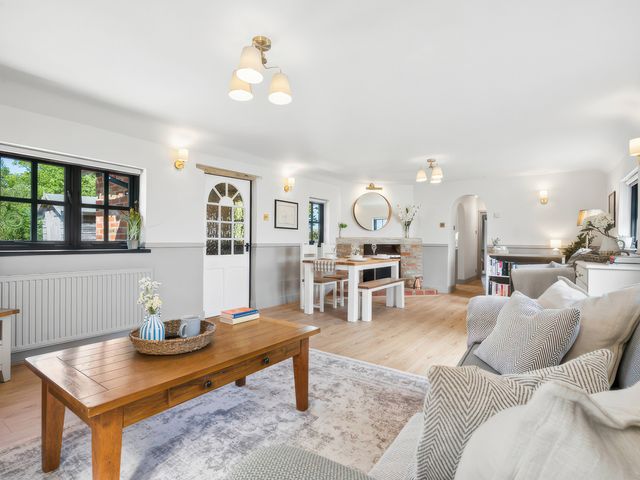 A living room with a table and chairs at 5 Acres Cottage in Rickmansworth