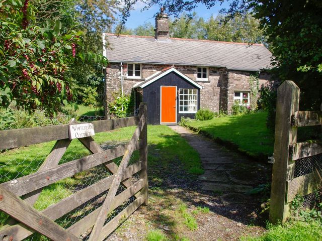 Cottage with orange door and gate at Whitefield Cottage in Barnstaple