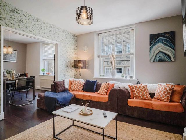 A living room with a sofa and coffee table at Licatas Apartment Cirencester Cotswolds Sleeps 6