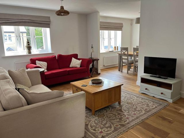 A living room with a sofa and coffee table at Apartment Sleeps 4 with Parking, Chagford