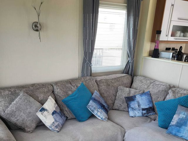 A living room with a sofa and window at BandR Turnberry Escape Scotland in Girvan