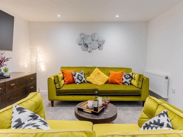 A living room with a sofa and coffee table at Cosy 2-Bed Apartment in Nettleham