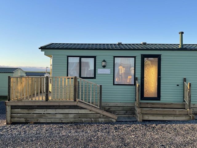 A static caravan with steps and a handrail at Beautiful 2 Bed Static caravan in 