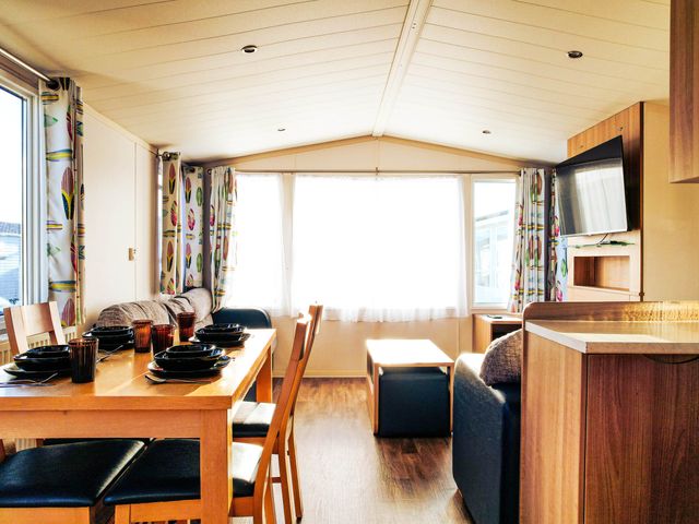 A living room with a dining table and chairs at Captivating 6-Person Caravan in Rhyl