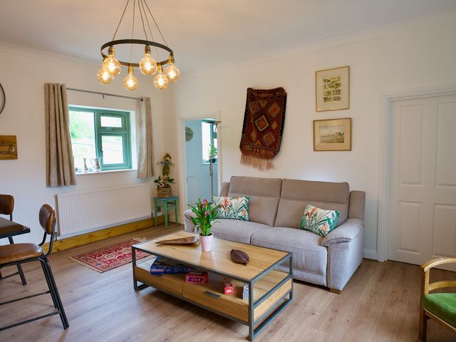 A living room with a sofa and coffee table at TBC 