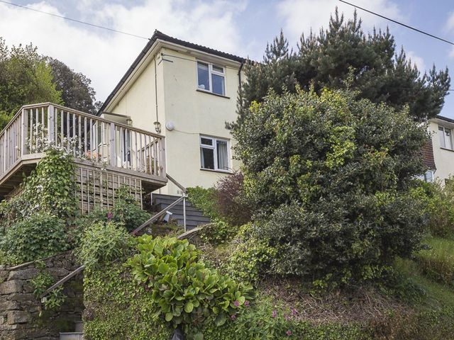 A house with a deck and stairs in front at 6 Knowle Court in Salcombe