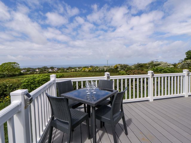 An outdoor patio with a table and chairs at The Dorchester at Bay View New Quay