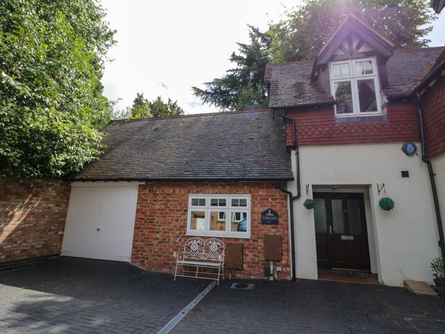 A house exterior with a garage and pathway at Tudor Lodge in Birmingham