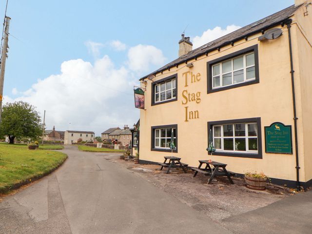 The Stag Inn building with outdoor tables and chairs at The Loft Apartment @ The Stag Inn Maryport