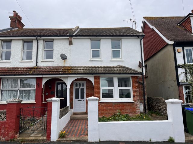 A house with brick wall and windows at 5a Bramber Road Seaford