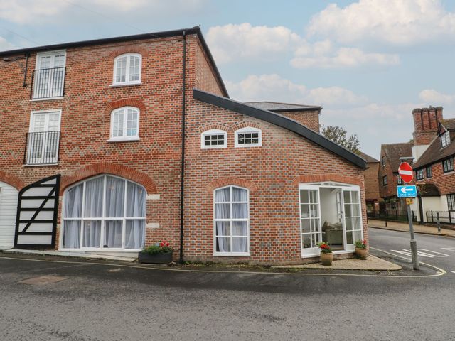 A brick building with windows and planters at 2 Bed in Bishop's Waltham