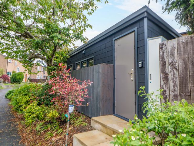 A cabin entrance with steps and plants at Dore Cabin Sheffield
