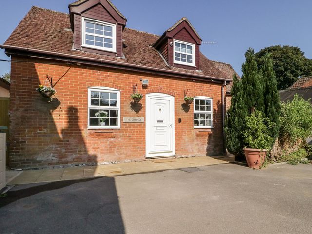 A cottage with a door and windows at The Cottage in Winterslow