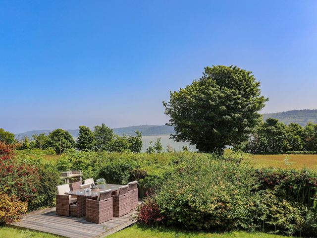 A garden with patio furniture and a view at Bryn Llifon in Pentraeth