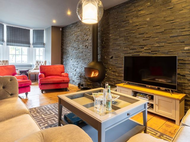 A living room with a sofa and armchairs at Prospect House in Windermere