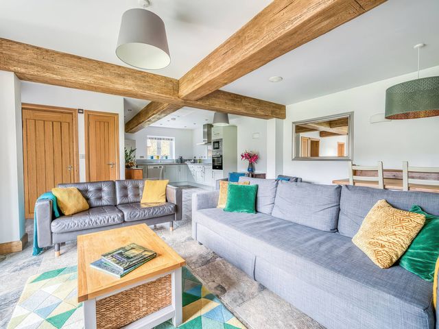 A living room with a sofa and coffee table at TBC 