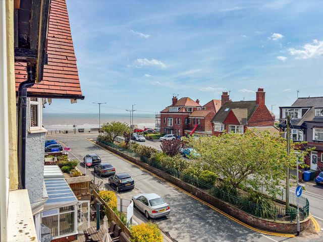 A view of houses, cars, and the sea at Tapestry House in Bridlington