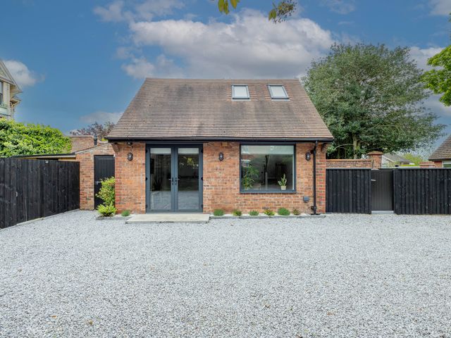 A house with gravel driveway and plants at Blackwood in Hornsea