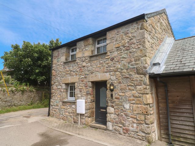 A stone building with a front door and windows at Gews Farm Lodge St Just