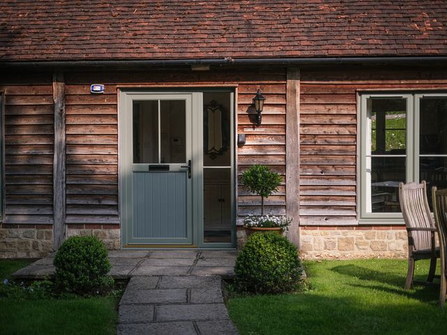 An entrance to a property with plants and outdoor furniture at Oaters Wood Petworth