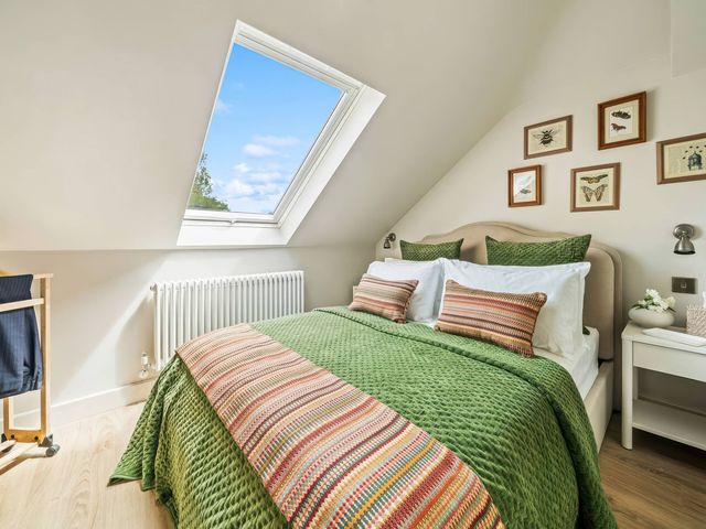 A bedroom with a bed and window at TBC
