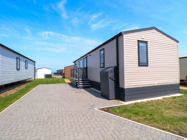 A mobile home with steps and a paved driveway at Sandy Shores Retreat in Norwich