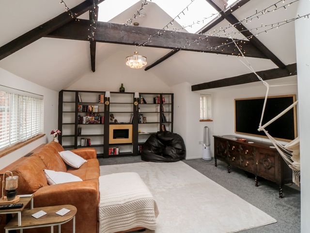 A living room with a sofa and bookshelf at The Joinery in Scarborough