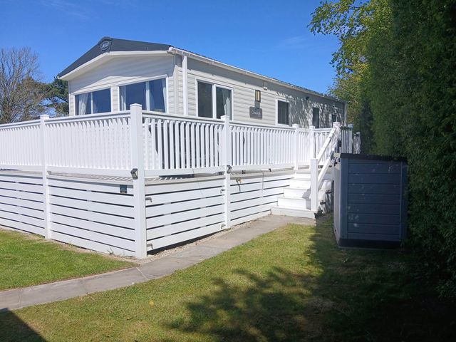 A mobile home with a deck and garden at Porthcurno 5, Perranwell near Goonhavern