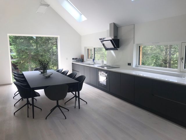 A kitchen with dining table and chairs at Red Stag with stunning loch and waterfall view, Crianlarich
