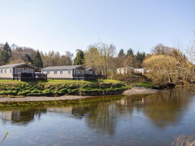 A view of caravans by a river at Hornshole Hideaway Caravan Hawick Riverside Caravan Park near Hawick