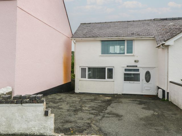 A house with a driveway next to another building at Porth Ewyn House in Trearddur Bay