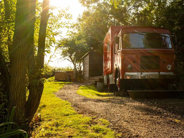 An outdoor scene with a truck and cabin by a hot tub at Sleeps 2 -Private Garden -Pets Ok -Hot Tub -Dennis